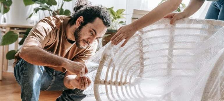 a couple using a bubble warp one of the most important packing materials