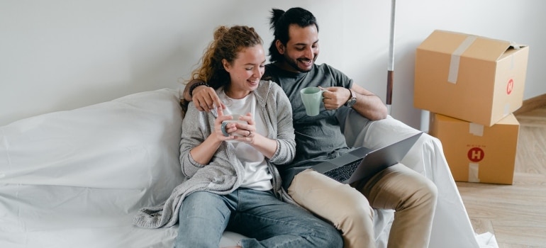 a couple searching the internet for the best moving choices