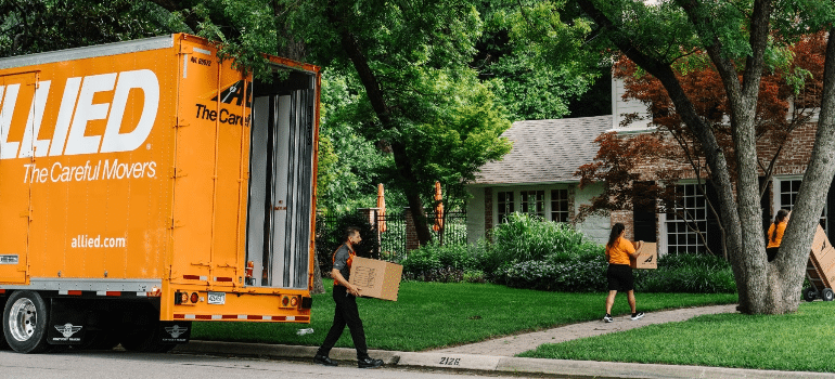 Movers unloading a truck wondering are major van lines on their way to extinction