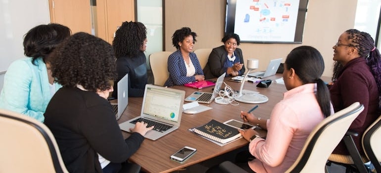 People having a meeting in a conference room.