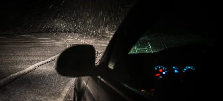 person driving a car while snowing