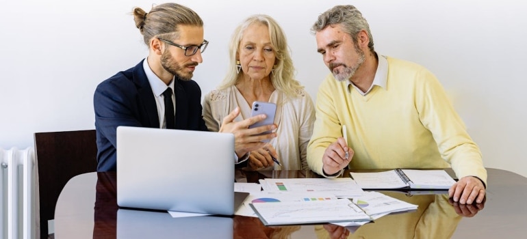 three business people checking insurance vs. valuation
