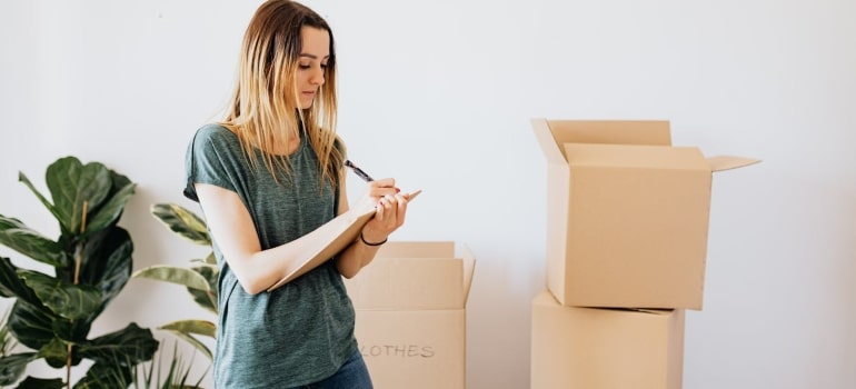 a woman making a list of items to declutter