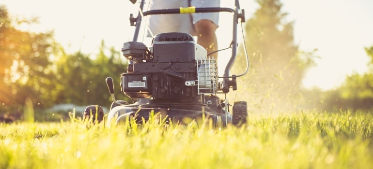 a person mowing the lawn