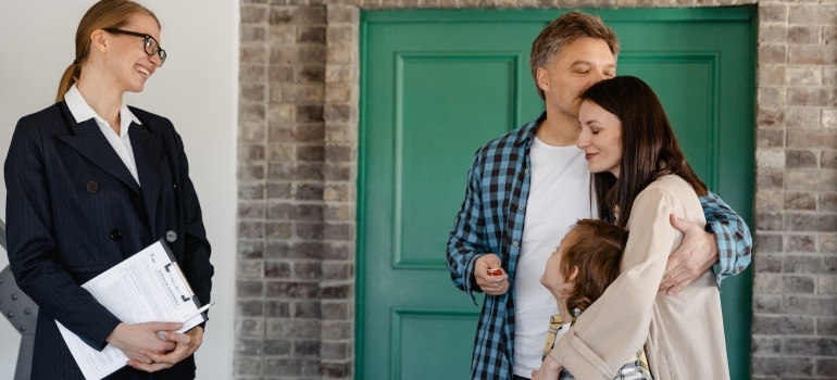 a family with a real estate agent checking the best CO places to relocate to