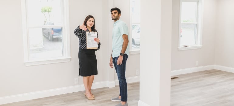a real estate agent showing a house to a man