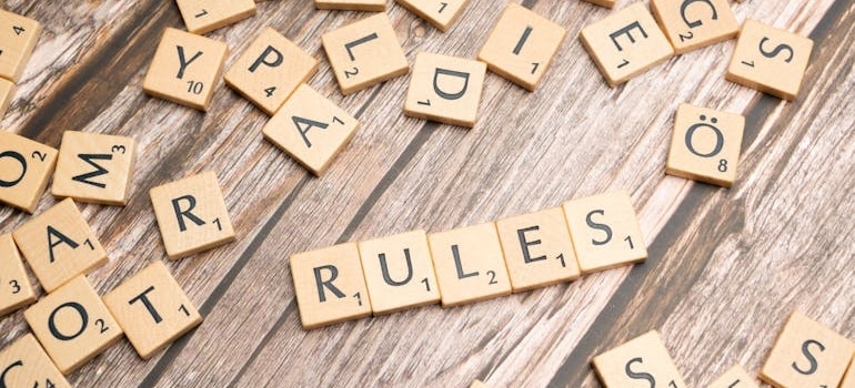 scrabble letters forming the word 'rules'