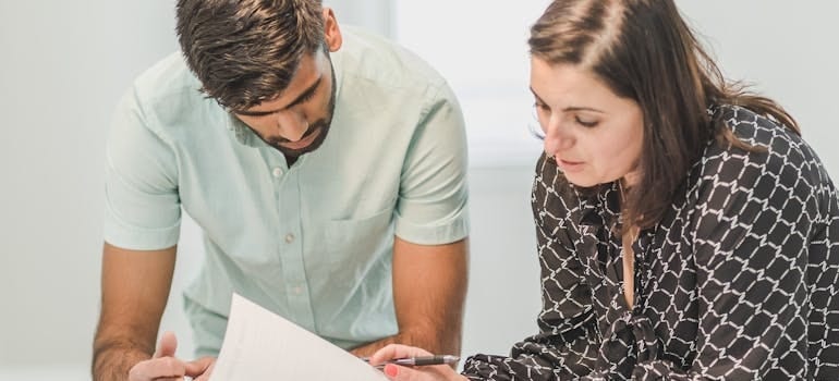 two people checking a document related to Colorado HOA laws