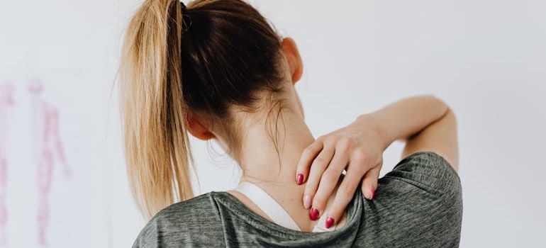 a woman touching her back