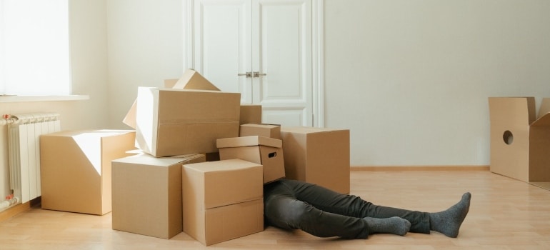 a man under boxes