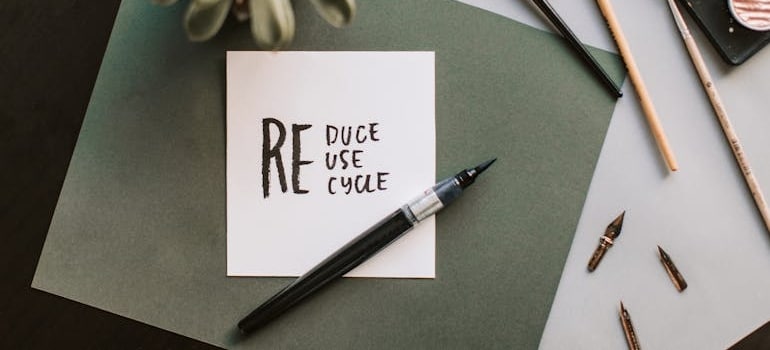 reuse, recycle, reduce written on a paper note