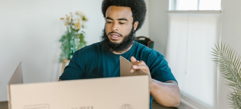 a mover making cardboard box