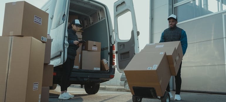 a mover loading boxes into a moving van